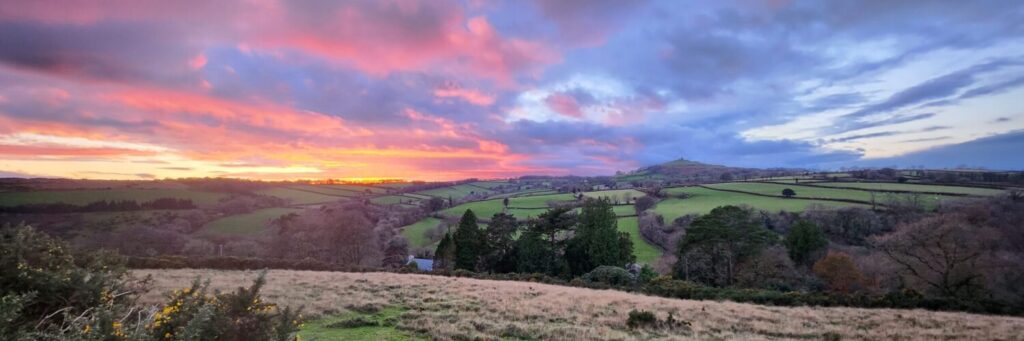 A view over the parish at sunset with Brent Tor on the horizon.